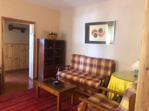 a living room with a couch and a table at Casa Valverde in Cartaxo