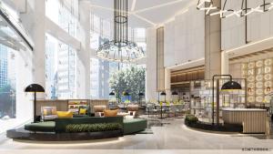 a lobby with couches and tables in a building at Holiday Inn Shanghai Nanjing Road by IHG in Shanghai