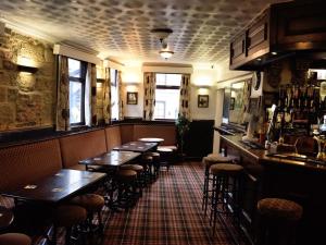 a restaurant with tables and stools in a room at The Granby hotel in Whitby