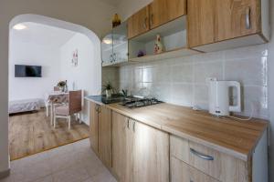 a kitchen with wooden cabinets and a counter top at Francisko in Grižane