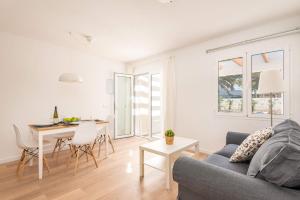 a living room with a couch and a table at Villa Ca Na Margarita by Villa Plus in Cala Blanca