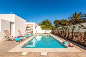 a swimming pool in the backyard of a house at Villa Ca Na Margarita by Villa Plus in Cala Blanca +10 photos