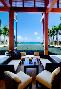 a living room with couches and a view of the ocean at Yalong Bay Mangrove Tree Resort in Sanya