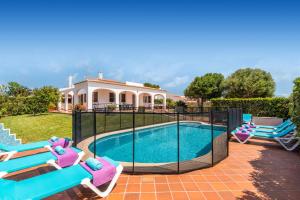 a villa with a swimming pool and a house at Villa Xaloc Blanes by Villa Plus in Cala Blanca