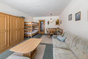 a living room with a couch and a table and a bunk bed at Haus Kreidl - Top 7 in Königsleiten