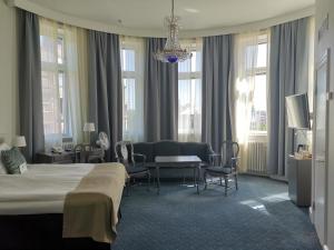 a hotel room with a bed and a living room at Crystal Plaza Hotel in Stockholm
