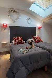 a bedroom with two beds with hearts on the wall at Goélia Les Chalets des Pistes in Combloux