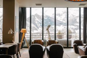 
a living room filled with furniture and a large window at Rooms Hotel Kazbegi in Stepantsminda

