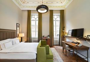 a hotel room with a bed and a desk and a chair at The Bank Hotel Istanbul, a Member of Design Hotels in Istanbul