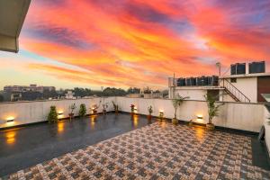 a view from the roof of a building with a sunset at FabHotel La Paz Stay B&B in New Delhi