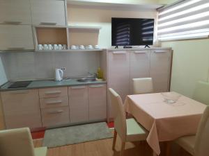 a small kitchen with a table and a table and chairs at Apartman Karadjordje 2 in Belgrade +4 photos