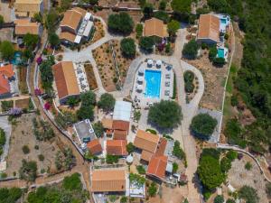 an overhead view of a house with a pool at Blue Horizon Cottages in Tzamarelláta