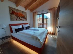 een slaapkamer met een bed en een groot raam bij Hochalmbahnen Chalets Rauris 1-04, Maislaufeldweg 1d in Rauris