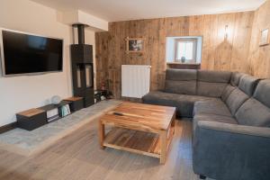 a living room with a couch and a coffee table at LE TOI DU MONDE in Flumet