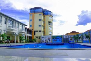 a building with a swimming pool in front of a building at Splendid Hotel in Gitarama