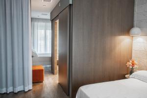 a hotel room with a bed and a window at AmbientHotels Panoramic in Rimini