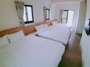 Кровать или кровати в номере 福門民宿
