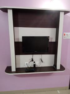 a flat screen tv on a shelf on a wall at Hotel Viraat Inn in Gaya
