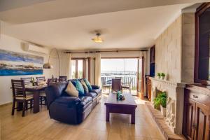 a living room with a couch and a table at Ideal Property Mallorca - Concha in Port d'Alcudia +13 photos