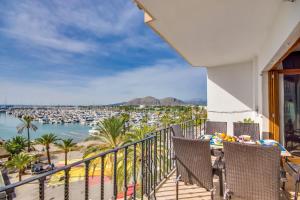 a balcony with chairs and a view of a marina at Concha in Port d'Alcudia