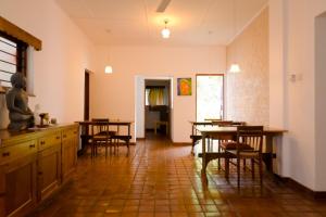 una cocina con mesas y sillas en una habitación en Clove Garden Kandy, en Kandy