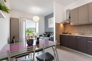 a kitchen and living room with a table and chairs at Apartments Zulijani House Helis B1 & B6 in Rabac