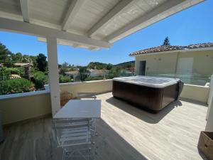 a hot tub on the deck of a house at Suimi's Hotel in Villasimius