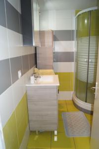 a bathroom with a sink and a mirror at appartement dans villa aquarelle in Biguglia +10 photos