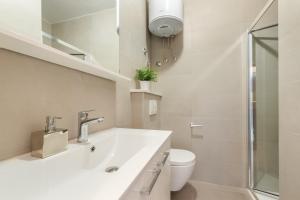 a white bathroom with a sink and a toilet at Apartments Zulijani House Helis B1 & B6 in Rabac +27 photos