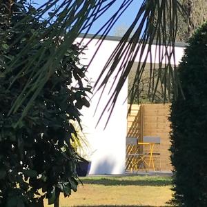 a yellow chair sitting next to a white building at le 25 l'océan in Saint-Hilaire-de-Riez