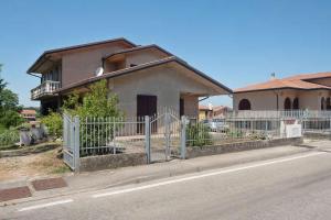 a house with a fence on the side of the road at appartamento da sauro in Rosolina
