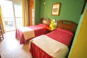 Ein Bett oder Betten in einem Zimmer der Unterkunft Hotel Arunda II