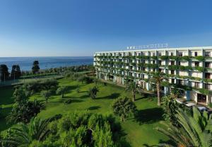an aerial view of a hotel with the ocean in the background at UNA Hotels Naxos Beach Sicilia in Giardini Naxos