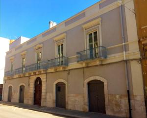 a building with balconies on the side of it at Palazzo Romanelli B&B in Trani