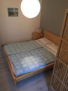 a small bedroom with a bed with a light at Casa Roby in Tremosine Sul Garda