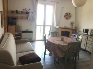 a living room with a table and a couch at Casa Roby in Tremosine Sul Garda +29 photos