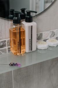 three bottles of soap sitting on a shelf in a bathroom at Paters Nessie in Paternoster +19 photos