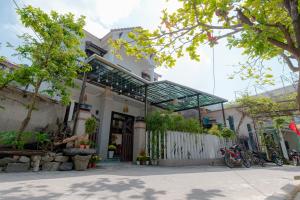 une maison blanche avec un toit en verre dans l'établissement Hammock Homestay, à Tân Hiệp