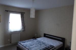 a small bedroom with a bed and a window at Au gite des viviers de la houle in Cancale +11 photos