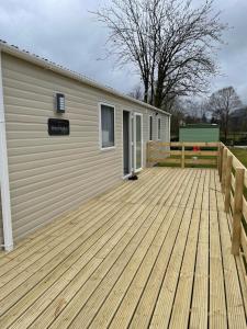 a large wooden deck next to a building at The Wimbledon in Dunoon