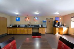 a large kitchen with a table and a refrigerator at Comfort Inn Near Gila National Forest in Silver City