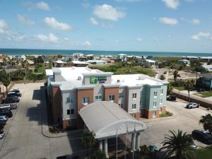 a view of a building with the ocean in the background at Holiday Inn Express Hotel and Suites Port Aransas/Beach Area by IHG in Port Aransas