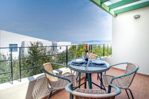a balcony with a table and chairs on a balcony at Palatia Village Hotel Apartments in Hersonissos