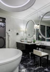 
a bathroom with a tub, sink and mirror at Lotte Hotel Moscow - The Leading Hotels of the World in Moscow
