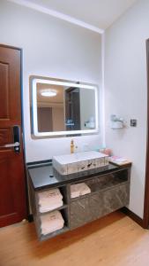 a bathroom with a sink and a mirror at 墾丁 後灣 微風海岸海景民宿 in Checheng