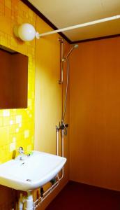 a bathroom with a white sink and a mirror at Stuga Ekesberget Stugby in Ekshärad