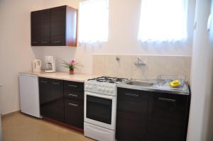 a kitchen with a white stove and a sink at Villa Swarzewo in Swarzewo