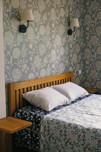 a bedroom with a bed and a wall with wallpaper at Niidupuu Holiday Home in Mändjala