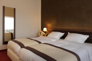 Postel nebo postele na pokoji v ubytování Golden Tulip Hotel de’ Medici