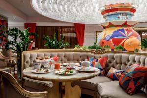 a dining room with a table with food on it at Lotte Hotel Moscow - The Leading Hotels of the World in Moscow